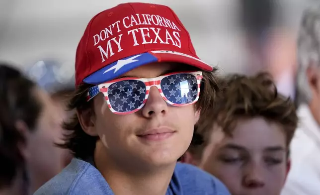 An attendee waits for Republican presidential nominee former President Donald Trump to speak at a news conference at Austin-Bergstrom International Airport, Friday, Oct. 25, 2024, in Austin, Texas. (AP Photo/Alex Brandon)