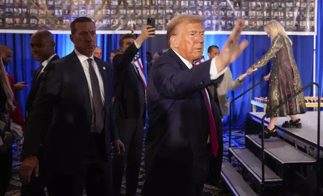 Republican presidential nominee former President Donald Trump waves as he departs an event marking one year since the Oct. 7 Hamas attack on Israel, Monday, Oct. 7, 2024, in Miami. (AP Photo/Alex Brandon)