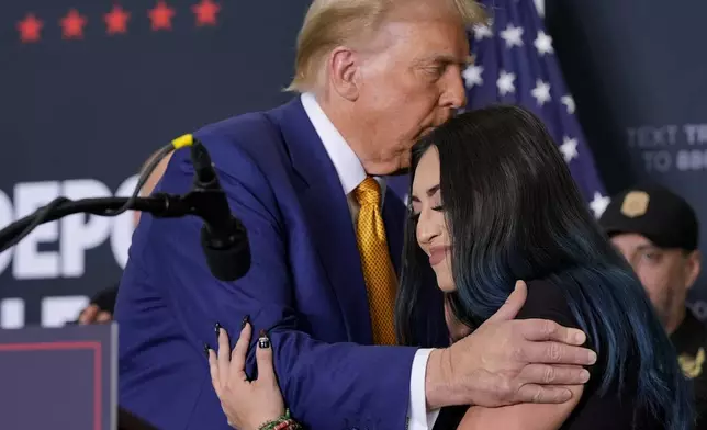 Republican presidential nominee former President Donald Trump, left, hugs Alexis Nungaray, mother of the late Jocelyn Nungaray, during a news conference at Austin-Bergstrom International Airport, Friday, Oct. 25, 2024, in Austin, Texas. (AP Photo/Alex Brandon)