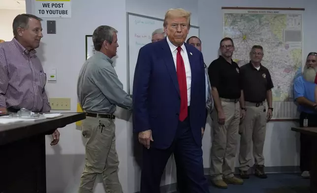 Republican presidential nominee former President Donald Trump arrives for a briefing at the Columbia County Emergency Management Agency as he visits areas impacted by Hurricane Helene, Friday, Oct. 4, 2024, in Evans, Ga. (AP Photo/Evan Vucci)