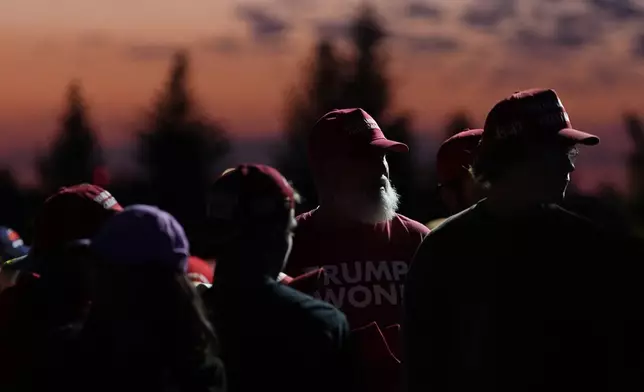 Supporters queue up as the sun rises to hear Republican presidential nominee former President Donald Trump speak at a campaign rally at the Gaylord Rockies Resort and Convention Center Friday, Oct. 11, 2024, in Aurora, Colo. (AP Photo/David Zalubowski)