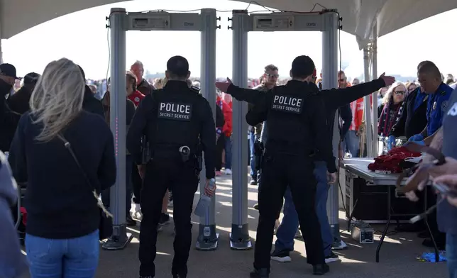 Attendees pass through security as they enter a campaign rally for Republican presidential nominee former President Donald Trump at Dodge County Airport, Sunday, Oct. 6, 2024, in Juneau, Wis. (AP Photo/Julia Demaree Nikhinson)