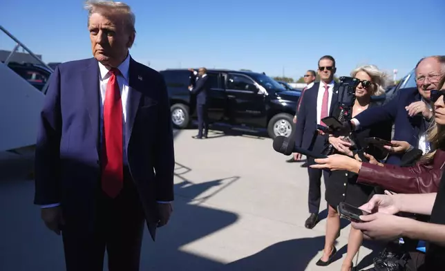 Republican presidential nominee former President Donald Trump speaks with reporters upon arrival at Philadelphia International Airport, Sunday, Oct. 20, 2024, in Philadelphia. (AP Photo/Evan Vucci)