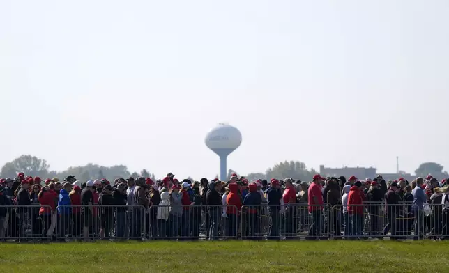 Attendees wait in line before a campaign rally for Republican presidential nominee former President Donald Trump at Dodge County Airport, Sunday, Oct. 6, 2024, in Juneau, Wis. (AP Photo/Julia Demaree Nikhinson)