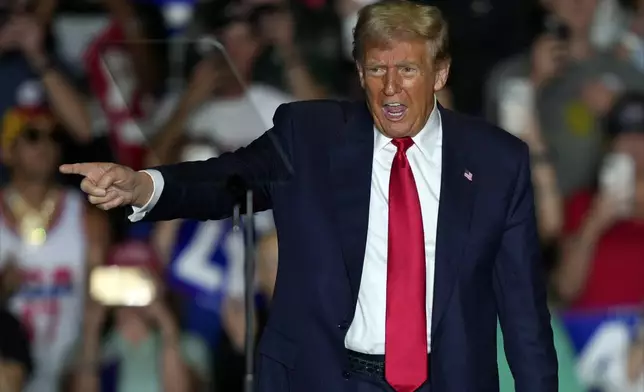 Republican presidential nominee former President Donald Trump gestures to supporters at a campaign rally at Greensboro Coliseum, Tuesday, Oct. 22, 2024, in Greensboro, N.C. (AP Photo/Julia Demaree Nikhinson)