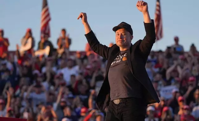 Elon Musk arrives on the stage as Republican presidential nominee former President Donald Trump speaks at a campaign rally at the Butler Farm Show, Saturday, Oct. 5, 2024, in Butler, Pa. (AP Photo/Evan Vucci)