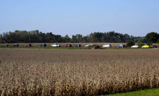 Cars drive to the entrance of a campaign rally for Republican presidential nominee former President Donald Trump at Dodge County Airport, Sunday, Oct. 6, 2024, in Juneau, Wis. (AP Photo/Julia Demaree Nikhinson)