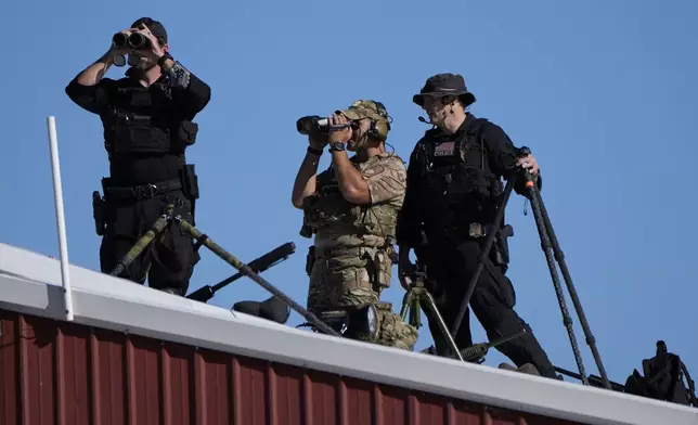 Members of law enforcement look on at a campaign event for Republican presidential nominee former President Donald Trump at the Butler Farm Show, Saturday, Oct. 5, 2024, in Butler, Pa. (AP Photo/Alex Brandon)