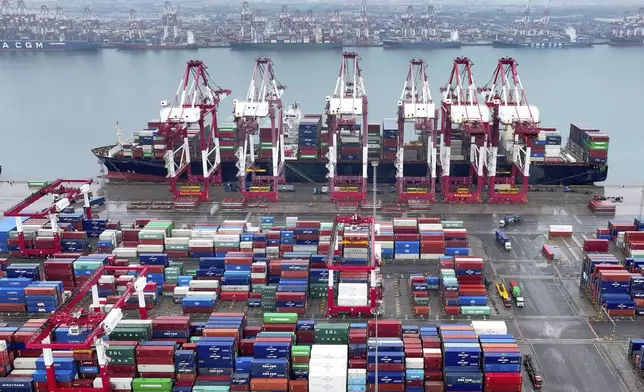 FILE - Cranes and transporters work at an automated container port in Qingdao in eastern China's Shandong province on July 7, 2024. (Chinatopix Via AP, File)