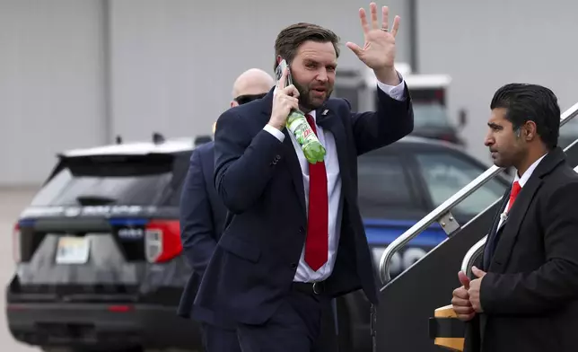 Republican vice presidential nominee Sen. JD Vance, R-Ohio, waves as he boards his plane at the Minneapolis/St. Paul International Airport, Monday, Oct. 14, 2024, after a campaign stop in Minneapolis. (AP Photo/Ellen Schmidt)