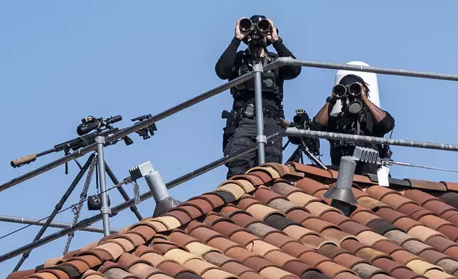 A counter-sniper team on the roof of the Commerce Department watches over a pro-Israel event attended by Republican Vice Presidential nominee Sen. JD Vance, R-Ohio, during a rally marking one year since the Oct. 7 Hamas terror attack on Israel, in Washington, Monday, Oct. 7, 2024. (AP Photo/J. Scott Applewhite)