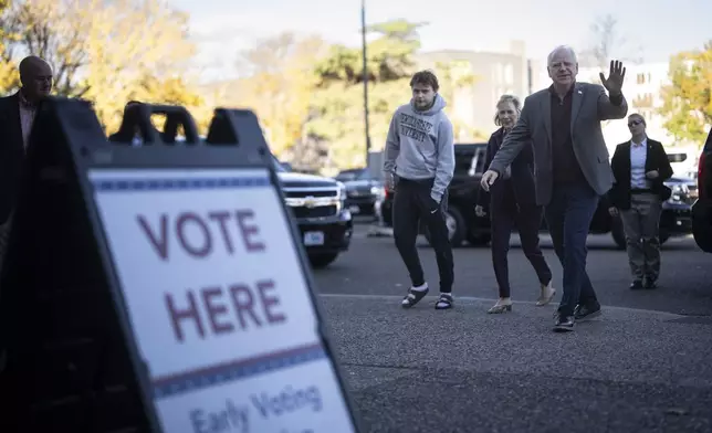 Minnesota Governor and Vice Presidential candidate Tim Walz enters the Ramsey County Elections office with his wife, Gwen, and son, Gus, to early vote in St. Paul, Minn., on Wednesday, October 23, 2024. (Renée Jones Schneider/Star Tribune via AP)