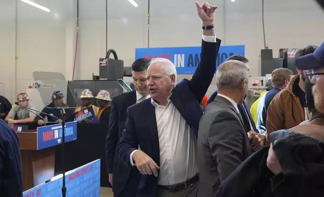 Democratic vice presidential nominee Minnesota Gov. Tim Walz greets supporters after speaking at a campaign event, Friday, Oct. 11, 2024, in Warren, Mich. (AP Photo/Carlos Osorio)