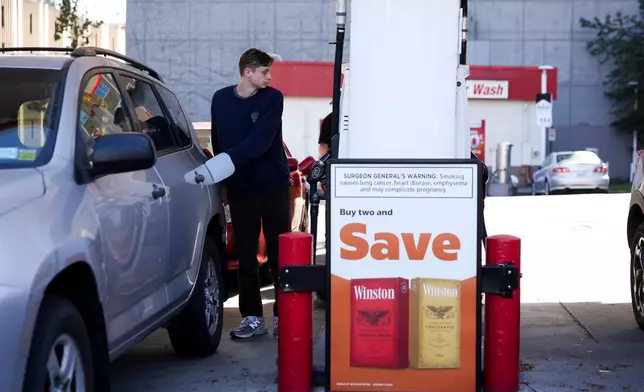 A driver fills up at a gasoline pump at a Shell gas station, Wednesday, Oct. 9, 2024, in Seattle. (AP Photo/Lindsey Wasson)