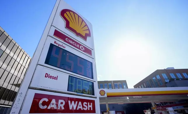 Prices are displayed on a corner sign at a Shell gas station, Wednesday, Oct. 9, 2024, in Seattle. (AP Photo/Lindsey Wasson)