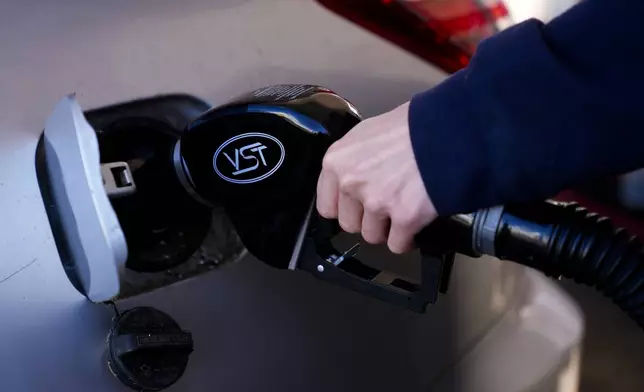 A driver fills up at a gasoline pump at a Shell gas station, Wednesday, Oct. 9, 2024, in Seattle. (AP Photo/Lindsey Wasson)