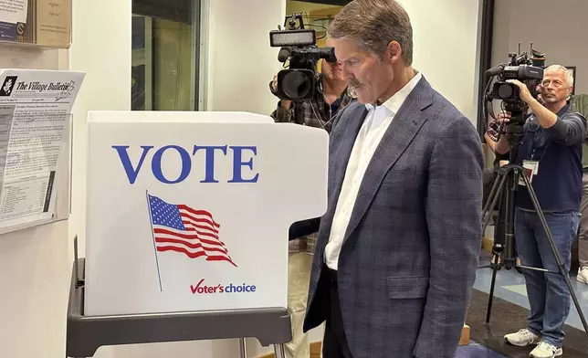 Republican U.S. Senate candidate Eric Hovde casts his ballot at the Village Hall in Shorewood Hills, Wis., Tuesday, Oct. 22, 2024, the first day of early in-person absentee voting in the battleground state. (AP Photo/Todd Richmond)