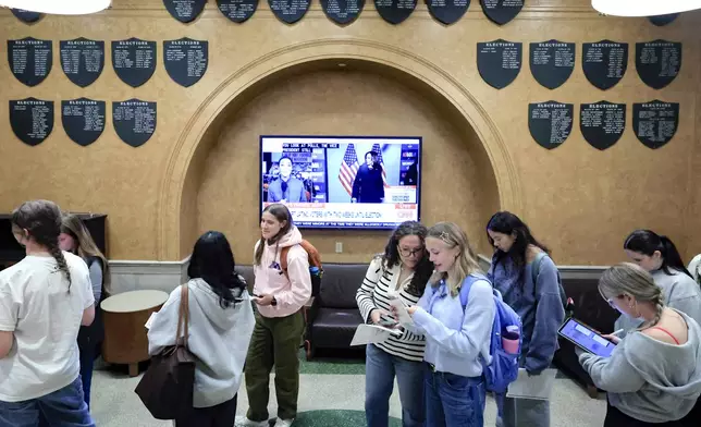 Students at The University of Wisconsin-Madison wait in line to cast their ballots in the 2024 election during the first day of Wisconsin's in-person absentee voting on the campus in Madison, Wisc., Tuesday, Oct. 22, 2024. (AP Photo/John Hart, Wisconsin State Journal)