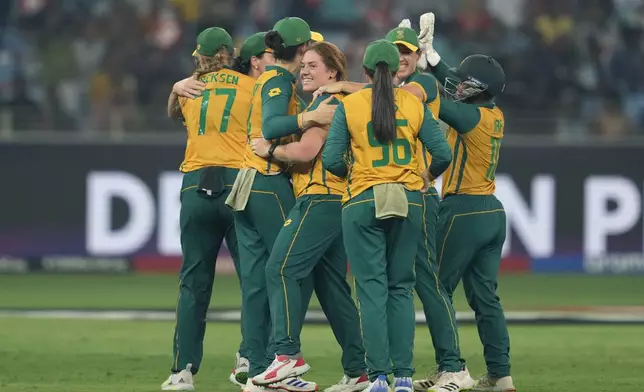 South Africa's Nadine de Klerk, center, without a cap, celebrates with teammates the wicket of New Zealand's captain Sophie Devine during the ICC Women's T20 World Cup 2024 final match between New Zealand and South Africa at Dubai, United Arab Emirates, Sunday, Oct. 20, 2024. (AP Photo/Altaf Qadri)