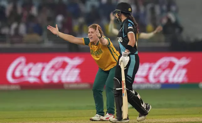 South Africa's Nadine de Klerk, left, appeals successfully for the wicket of New Zealand's captain Sophie Devine during the ICC Women's T20 World Cup 2024 final match between New Zealand and South Africa at Dubai, United Arab Emirates, Sunday, Oct. 20, 2024. (AP Photo/Altaf Qadri)