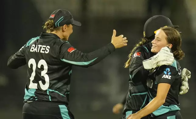 New Zealand's Eden Carson, right, celebrates with teammates after the dismissal of West Indies' Stafanie Taylor during the ICC Women's T20 World Cup 2024 semi-final match between New Zealand and West Indies at Sharjah Stadium, United Arab Emirates, Friday, Oct. 18, 2024. (AP Photo/Altaf Qadri)