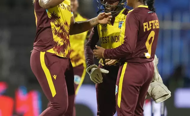 West Indies' Afy Fletcher, right, celebrates with teammates after the dismissal of New Zealand's captain Sophie Devine during the ICC Women's T20 World Cup 2024 semi-final match between New Zealand and West Indies at Sharjah Stadium, United Arab Emirates, Friday, Oct. 18, 2024. (AP Photo/Altaf Qadri)