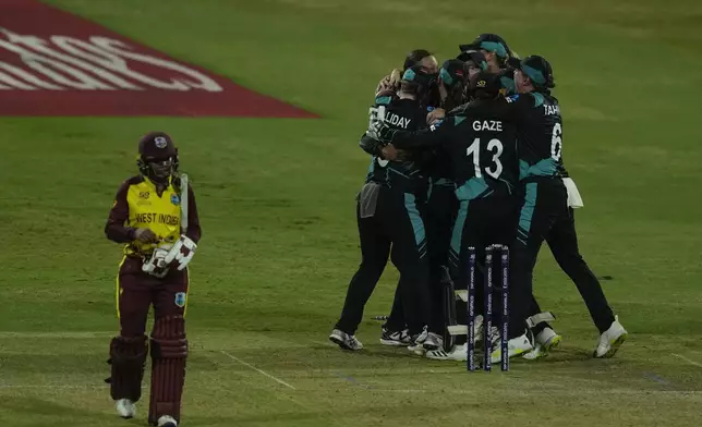 New Zealand's players celebrate after wining against West Indies' during the ICC Women's T20 World Cup 2024 semi-final match at Dubai International Cricket Stadium, United Arab Emirates, Friday, Oct. 18, 2024. (AP Photo/Altaf Qadri)