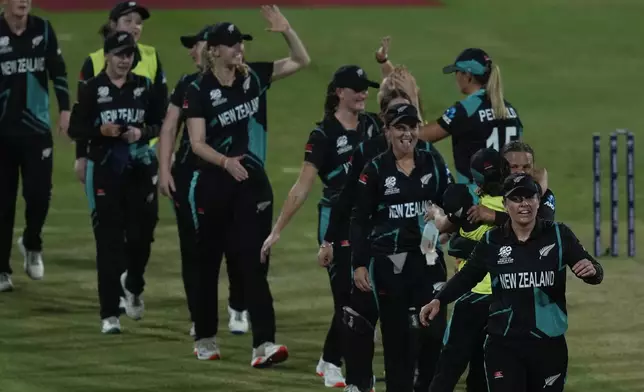 New Zealand's players celebrate after wining against West Indies' during the ICC Women's T20 World Cup 2024 semi-final match at Dubai International Cricket Stadium, United Arab Emirates, Friday, Oct. 18, 2024. (AP Photo/Altaf Qadri)