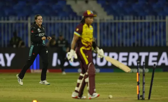 New Zealand's Fran Jonas, left, celebrates the dismissal of West Indies' Chedean Nationduring the ICC Women's T20 World Cup 2024 semi-final match between New Zealand and West Indies at Sharjah Stadium, United Arab Emirates, Friday, Oct. 18, 2024. (AP Photo/Altaf Qadri)