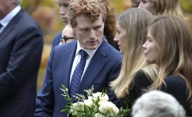 Joseph Kennedy III, center, grandson of Ethel Kennedy, speaks to his wife Lauren Birchfield, second right, following funeral services for Ethel Kennedy at Our Lady of Victory church, Monday, Oct. 14, 2024, in Centerville, Mass. (AP Photo/Steven Senne)