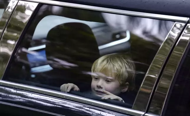 James Kennedy, great grandson of Ethel Kennedy, wife of Sen. Robert F. Kennedy, is seated in a vehicle that forms part of a funeral procession departing Our Lady of Victory church, following funeral services for Ethel Kennedy, Monday, Oct. 14, 2024, in Centerville, Mass. (AP Photo/Steven Senne)