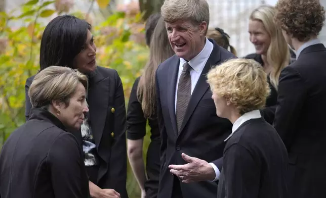 Former U.S. Rep. Patrick Kennedy, center right above, grandson of the late Ethel Kennedy, speaks with Massachusetts Gov. Maura Healey, below left, as they depart Our Lady of Victory church following funeral services for Ethel Kennedy, wife of Sen. Robert F. Kennedy, Monday, Oct. 14, 2024, in Centerville, Mass. (AP Photo/Steven Senne)