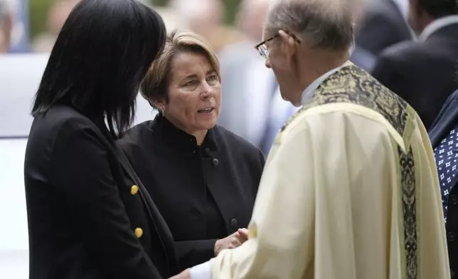 Massachusetts Gov. Maura Healey, center, speaks with Monsignor Kenneth Velo, right, following funeral services for Ethel Kennedy, wife of the late Sen. Robert F. Kennedy, at Our Lady of Victory church, Monday, Oct. 14, 2024, in Centerville, Mass. (AP Photo/Steven Senne)