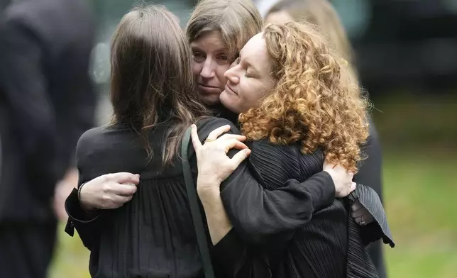 Mourners hug following funeral services for Ethel Kennedy, wife of the late Sen. Robert F. Kennedy, at Our Lady of Victory church, Monday, Oct. 14, 2024, in Centerville, Mass. (AP Photo/Steven Senne)