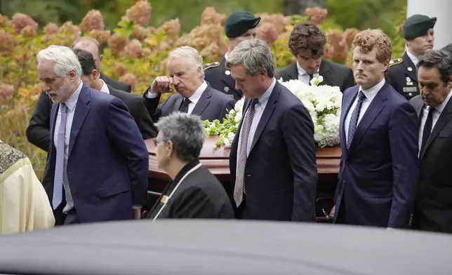 Pallbearers Max Kennedy, left, Chris Kennedy, behind center left, both sons of the late Ethel Kennedy, and Matt Kennedy, center front, and, Joseph Kennedy III, front second from right, both grandsons of Ethel Kennedy, carry her casket from Our Lady of Victory church, following funeral services, Monday, Oct. 14, 2024, in Centerville, Mass. (AP Photo/Steven Senne)