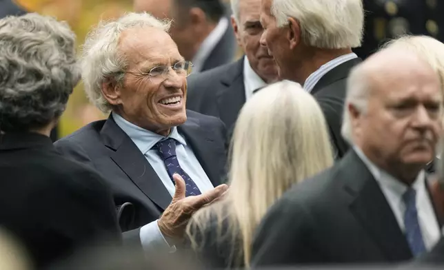 Former Massachusetts U.S. Rep. Joseph Kennedy II, center left, son of the late Ethel Kennedy, speaks with fellow mourners outside Our Lady of Victory church, following funeral services for Ethel Kennedy, Monday, Oct. 14, 2024, in Centerville, Mass. (AP Photo/Steven Senne)