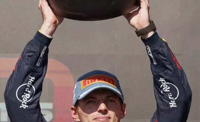 Red Bull driver Max Verstappen, of the Netherlands, holds up his third place trophy after the Formula One U.S. Grand Prix auto race at Circuit of the Americas, Sunday, Oct. 20, 2024, in Austin, Texas. (AP Photo/Nick Didlick)