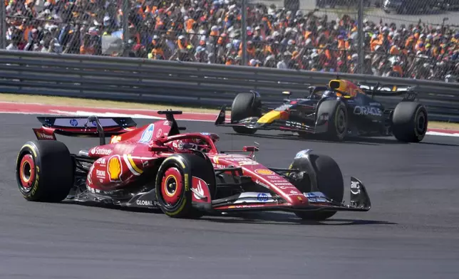 Ferrari driver Charles Leclerc, of Monaco, leads Red Bull driver Max Verstappen, of the Netherlands, through a turn during the U.S. Grand Prix auto race at Circuit of the Americas, Sunday, Oct. 20, 2024, in Austin, Texas. (AP Photo/Eric Gay)