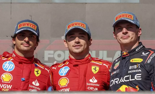 Ferrari drivers Carlos Sainz, from left, of Spain, who finished in second stands by race winner and teammate Charles Leclerc, of Monaco, and Red Bull driver Max Verstappen, of the Netherlands, who placed third in the U.S. Grand Prix auto race at Circuit of the Americas, Sunday, Oct. 20, 2024, in Austin, Texas. (AP Photo/Nick Didlick)