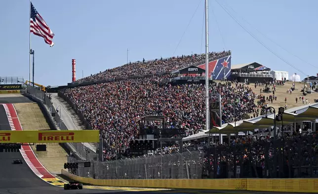 Fans watch as drivers race in the F1 U.S. Grand Prix auto race at the Circuit of the Americas, Sunday, Oct. 20, 2024, in Austin, Texas. (Patrick Fallon/Pool Photo via AP)