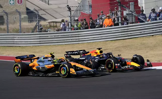 McLaren driver Lando Norris, left, of Britain, and Red Bull driver Max Verstappen, right, of the Netherlands, race through a turn during the U.S. Grand Prix auto race at Circuit of the Americas, Sunday, Oct. 20, 2024, in Austin, Texas. (AP Photo/Eric Gay)