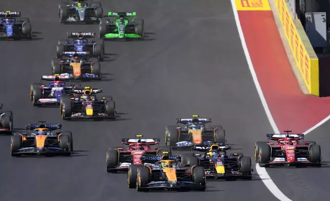 McLaren driver Lando Norris, of Britain, leads drives into Turn 1 during the U.S. Grand Prix auto race at Circuit of the Americas, Sunday, Oct. 20, 2024, in Austin, Texas. (AP Photo/Eric Gay)