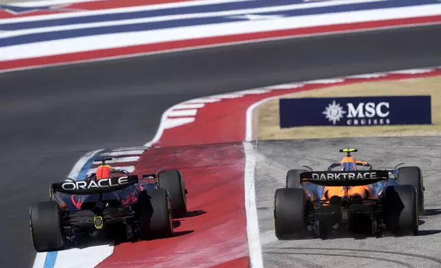 Red Bull driver Max Verstappen, left, of the Netherlands, runs McLaren driver Lando Norris, right, of Britain, off the track at Turn 1 during the U.S. Grand Prix auto race at Circuit of the Americas, Sunday, Oct. 20, 2024, in Austin, Texas. (AP Photo/Eric Gay)