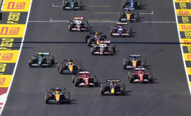 McLaren driver Lando Norris, left front, of Britain, and Red Bull driver Max Verstappen, right front, of the Netherlands, lead drivers at the start of the U.S. Grand Prix auto race at Circuit of the Americas, Sunday, Oct. 20, 2024, in Austin, Texas. (AP Photo/Eric Gay)