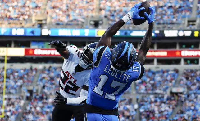 Carolina Panthers wide receiver Xavier Legette (17) scores a touchdown against Atlanta Falcons cornerback Clark Phillips III (22) in the first half of an NFL football game in Charlotte, N.C., Sunday, Oct. 13, 2024. (AP Photo/Jacob Kupferman)