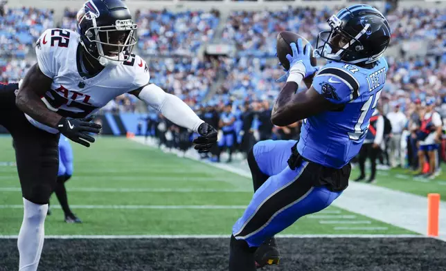 Carolina Panthers wide receiver Xavier Legette (17) scores a touchdown against Atlanta Falcons cornerback Clark Phillips III (22) in the first half of an NFL football game in Charlotte, N.C., Sunday, Oct. 13, 2024. (AP Photo/Jacob Kupferman)