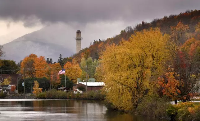 Fall foliage adds color to a rainy day along the Androscoggin River, Wednesday, Oct. 16, 2024, in Berlin, N.H. (AP Photo/Robert F. Bukaty)