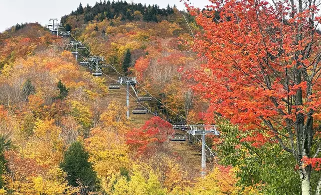 Fall colors are displayed on Loon Mountain near Lincoln, N.H., Tuesday, Oct. 15, 2024. (AP Photo/Nick Perry)