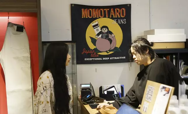 Shop clarks work at Momotaro Jeans shop in Tokyo, on Sept. 18, 2024. (AP Photo/Eugene Hoshiko)