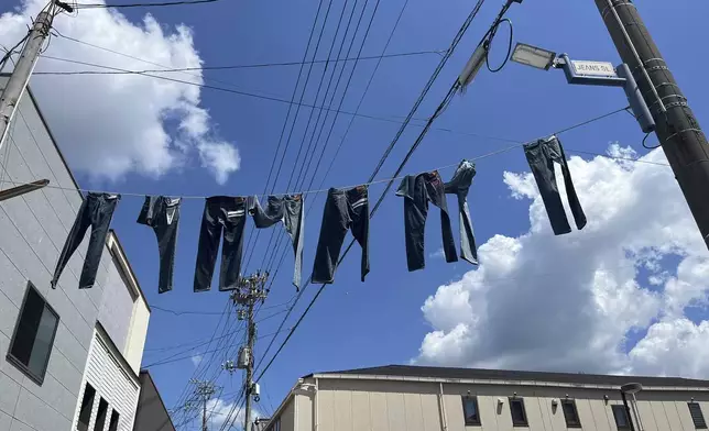 Pairs of jeans flap over Jeans Street in Kojima, Okayama prefecture, Japan, on Sept. 4, 2024. (AP Photo/Yuri Kageyama)